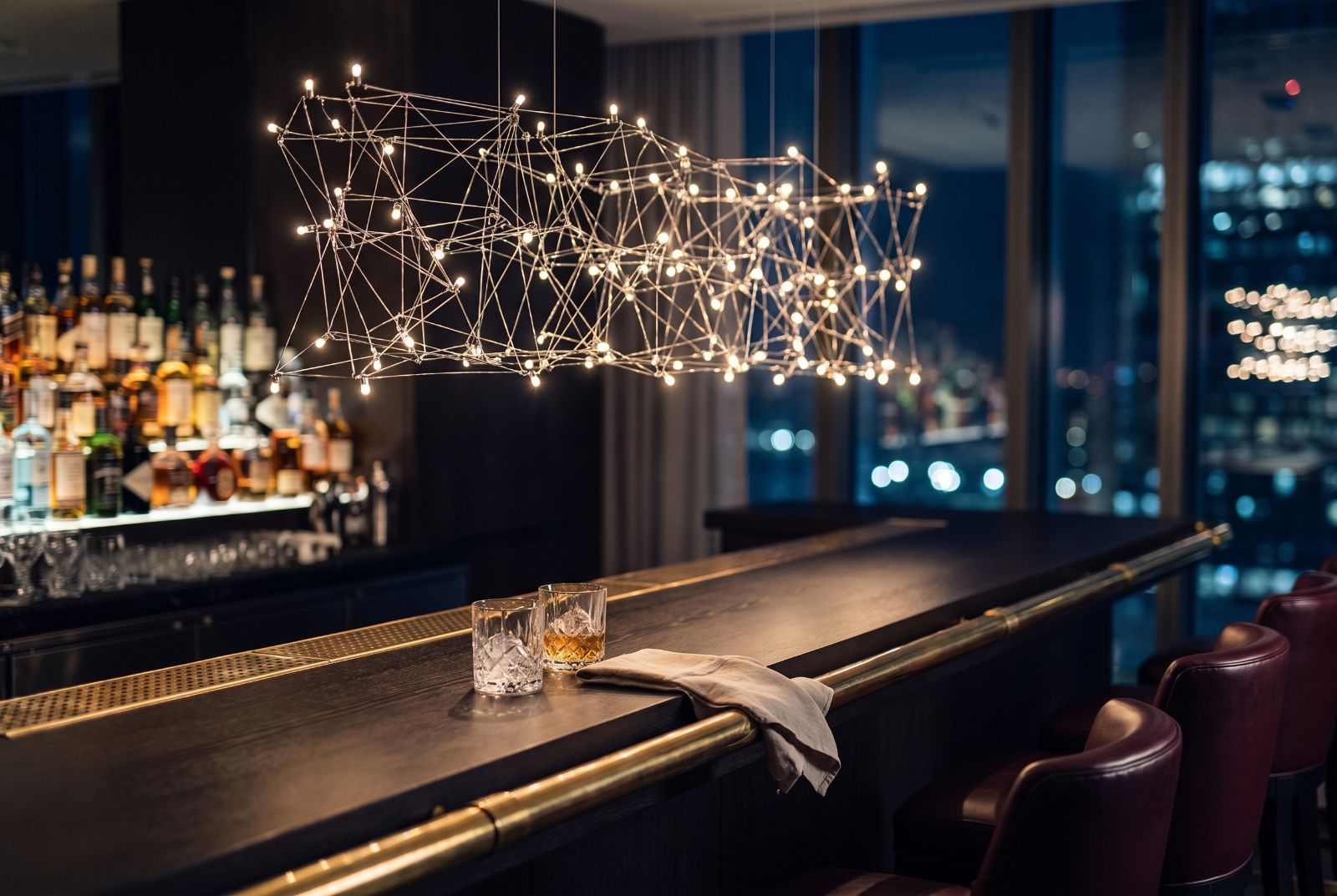 Astron Line pendant above a luxury bar and lounge at night